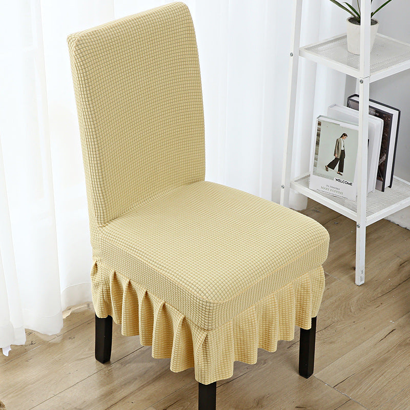 The chair cover has a skirt, is thick, stain-resistant, and elastic.