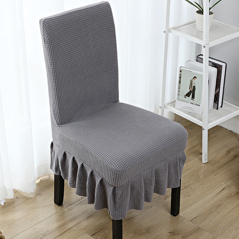 The chair cover has a skirt, is thick, stain-resistant, and elastic.