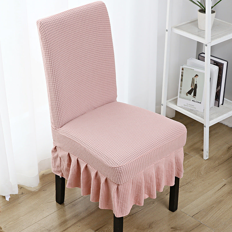 The chair cover has a skirt, is thick, stain-resistant, and elastic.