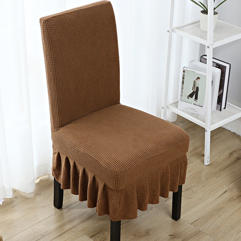 The chair cover has a skirt, is thick, stain-resistant, and elastic.