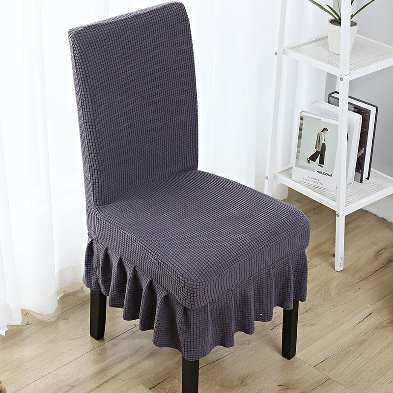 The chair cover has a skirt, is thick, stain-resistant, and elastic.